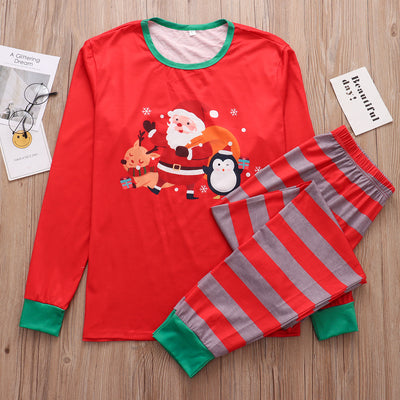Family of five and pets wearing matching red and grey striped Christmas pajamas with Santa and penguin print. - Image 4