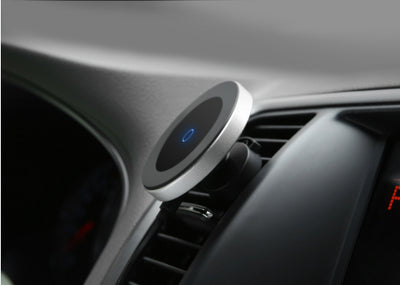 Silver and black car magnetic wireless charger with a blue indicator light, mounted on a car's air vent. - Image 8