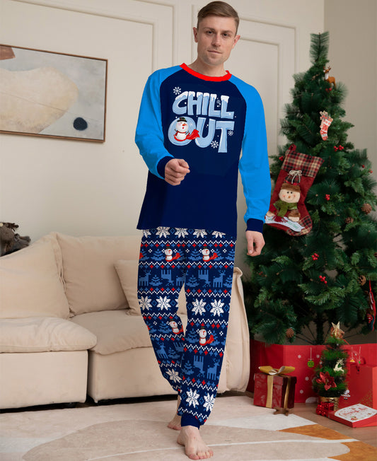 Woman wearing a navy blue and light blue Christmas pajama set with a "CHILL OUT" snowman graphic and fair isle patterned pants. - Image 2