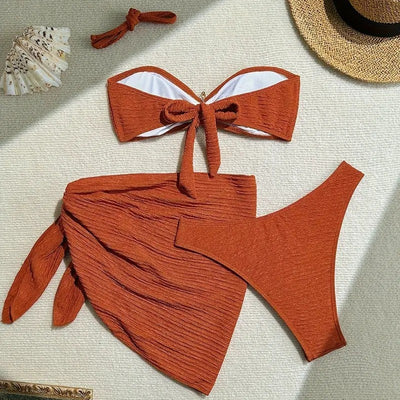 Rust three-piece swimsuit with textured fabric, featuring a tube top with a starfish, high-cut bottoms, and a sarong. - Image 7