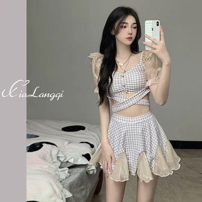 Women's conservative two-piece swimsuit with beige and white houndstooth pattern, sheer puff sleeves, and a flared skirt.