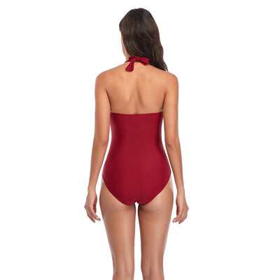 Woman wearing a red halterneck one-piece swimsuit with a V-neckline and ruched detailing on the torso. - Image 24