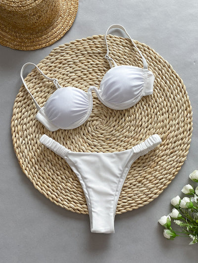 Rust underwire bikini set with ruched top and high-cut bottom, displayed on a woven mat. - Image 7