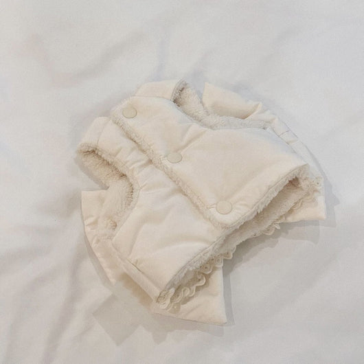 Creamy-white plush dog harness with a large decorative bow on the back, worn by a small poodle-like dog. - Image 9