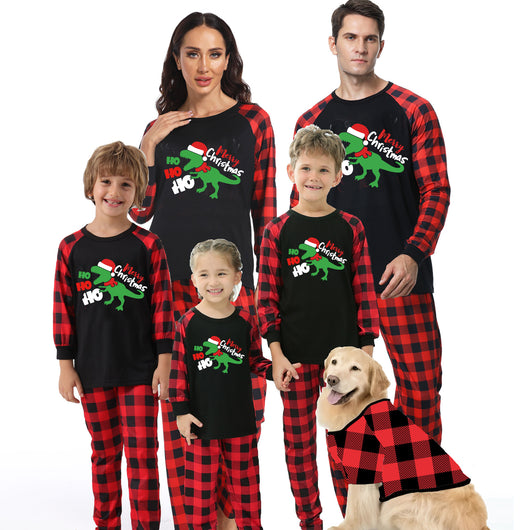 Black baby romper with red plaid sleeves and cuffs, featuring a green dinosaur wearing a Santa hat and "Merry Christmas" text.
