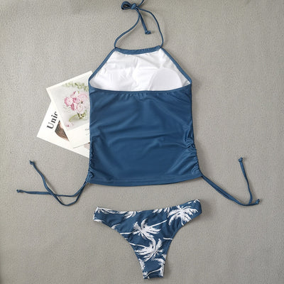 Women's blue halter tankini top with white palm tree graphic and "live simple" text, paired with matching high-waist bikini bottoms with palm print and side tie - Image 20