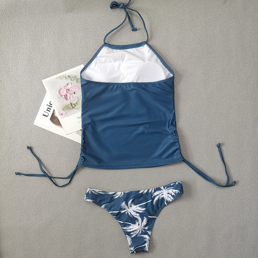 Women's blue halter tankini top with white palm tree graphic and "live simple" text, paired with matching high-waist bikini bottoms with palm print and side tie - Image 20