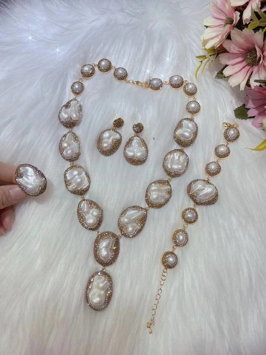 Baroque pearl necklace, ring, earrings, and bracelet set with gold-toned settings and sparkling accents. - Image 11