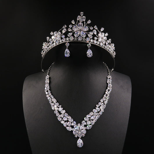 Sparkling bridal jewelry set with a silver-tone crown, necklace, and teardrop earrings, adorned with clear crystals.