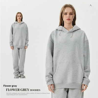 Young woman wearing a pink fleece-lined hoodie and matching sweatpants tracksuit set with a drawstring hood and kangaroo pocket. - Image 6