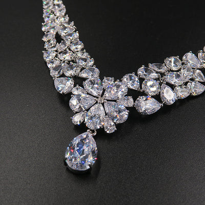 Sparkling bridal jewelry set with a silver-tone crown, necklace, and teardrop earrings, adorned with clear crystals. - Image 5