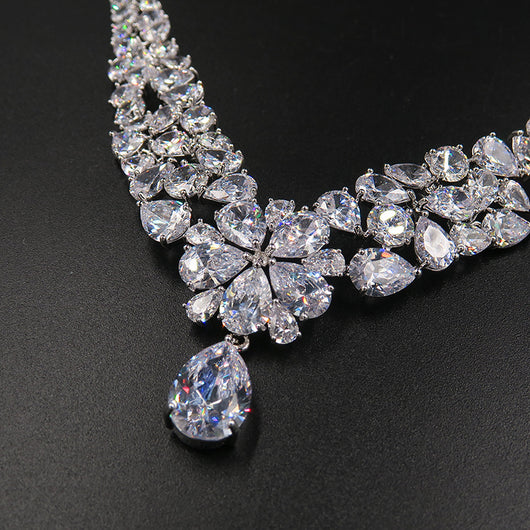 Sparkling bridal jewelry set with a silver-tone crown, necklace, and teardrop earrings, adorned with clear crystals. - Image 5