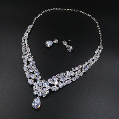 Sparkling bridal jewelry set with a silver-tone crown, necklace, and teardrop earrings, adorned with clear crystals. - Image 3