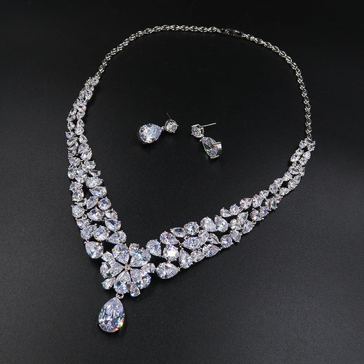Sparkling bridal jewelry set with a silver-tone crown, necklace, and teardrop earrings, adorned with clear crystals. - Image 3