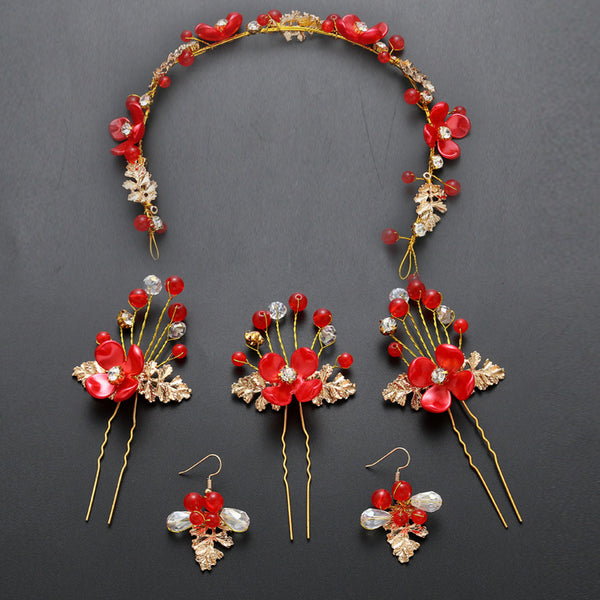 Red floral wedding costume jewelry set with a headdress, three hairpins, and two dangle earrings.