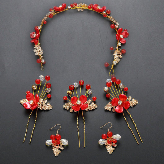 Red floral wedding costume jewelry set with a headdress, three hairpins, and two dangle earrings.