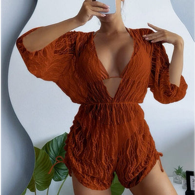 Woman wearing a white and black tie-dye beach cover-up romper with a deep V-neck and drawstring sides. - Image 11