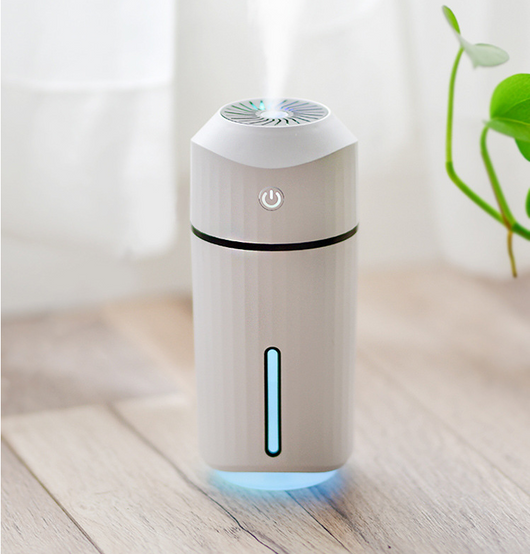 Pink columnar mini car humidifier with a power button and a clear water level indicator on a white background. - Image 5