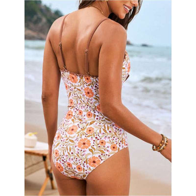 Women's floral print one-piece swimsuit with shoulder straps and matching lace-up beach skirt on a sandy beach. - Image 4