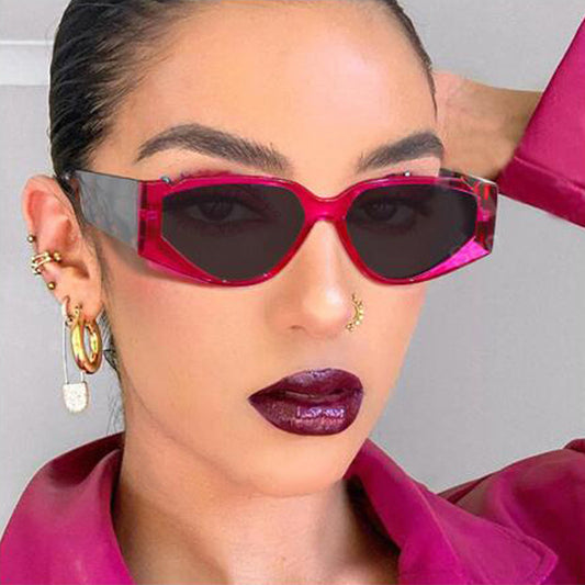 Vintage triangle notch sunglasses with brown lenses and leopard print frames and temples.