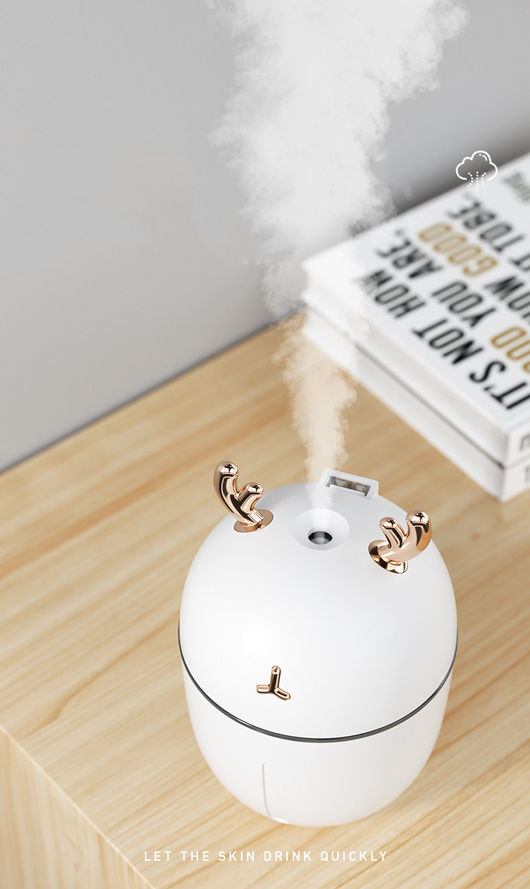 Pink deer-shaped mini humidifier with gold antlers and a glowing blue light band, on a pink background. - Image 4