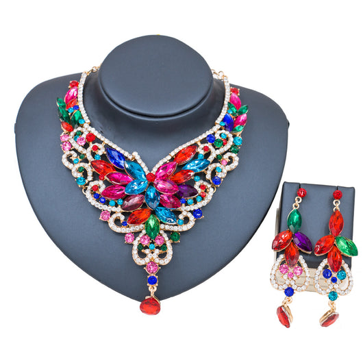Exaggerated green gemstone necklace and matching dangle earrings set with gold-tone metal and clear accents. - Image 12