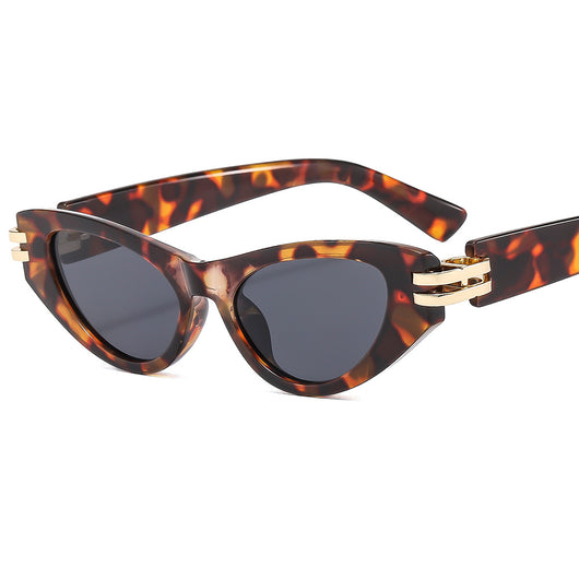 Black cat-eye sunglasses with dark gray lenses and gold-tone hinge accents on a white background. - Image 22