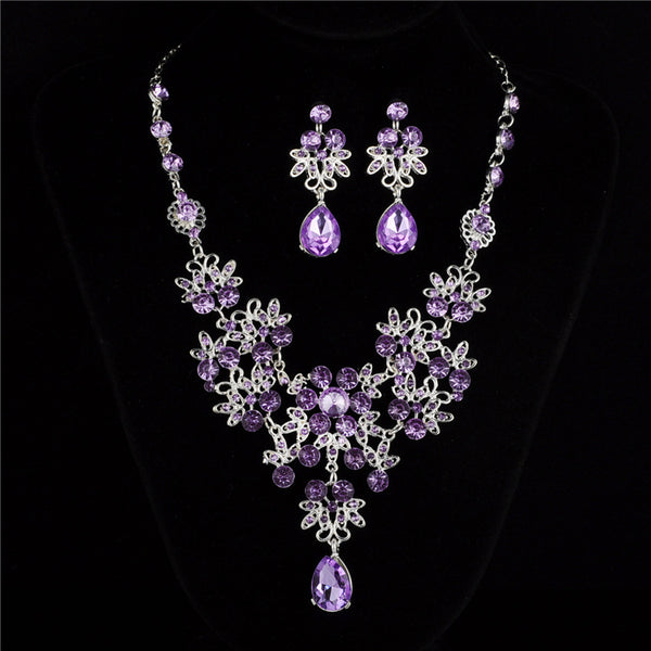 Silver-tone necklace and matching drop earrings set with clear rhinestones and teardrop crystals, ideal for weddings.