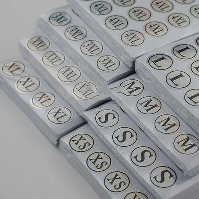 Stack of round clothing size stickers with laser color-changing background and black text, from XS to 4XL. - Image 3