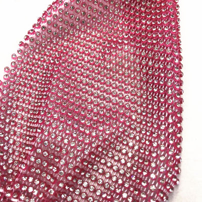 Close-up of a blue mesh fabric adorned with numerous small, clear rhinestones, creating a sparkling texture. - Image 34