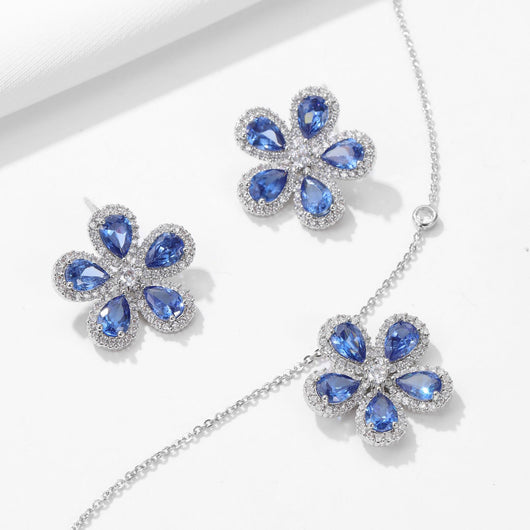Elegant jewelry set with a silver-tone necklace and matching stud earrings, featuring blue and clear floral gemstones. - Image 12