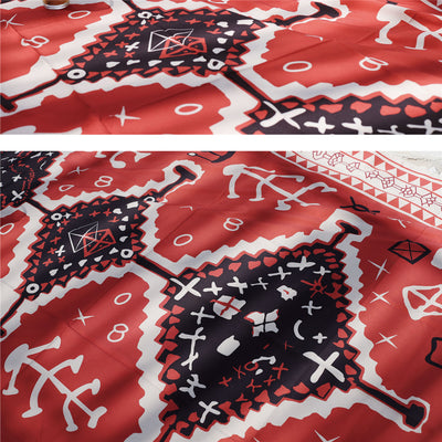 Red tapestry with black and white geometric tribal pattern hanging on a white wall above decorative pillows. - Image 10