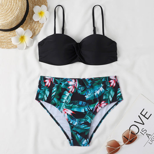 Teal twisted bandeau bikini top with tropical leaf print high-waisted bottoms on a model wearing a white shirt. - Image 7