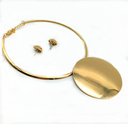 Silver-tone choker necklace with a large, flat circular pendant and matching round stud earrings on a black display. - Image 2