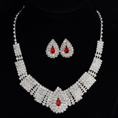 Sparkling bridal necklace and matching teardrop rhinestone earrings set on a black background. - Image 4