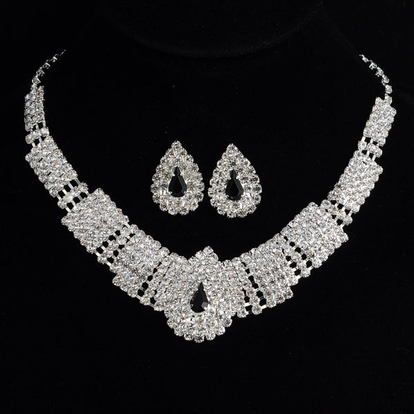 Sparkling bridal necklace and matching teardrop rhinestone earrings set on a black background. - Image 5