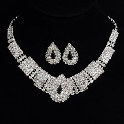 Sparkling bridal necklace and matching teardrop rhinestone earrings set on a black background. - Image 5