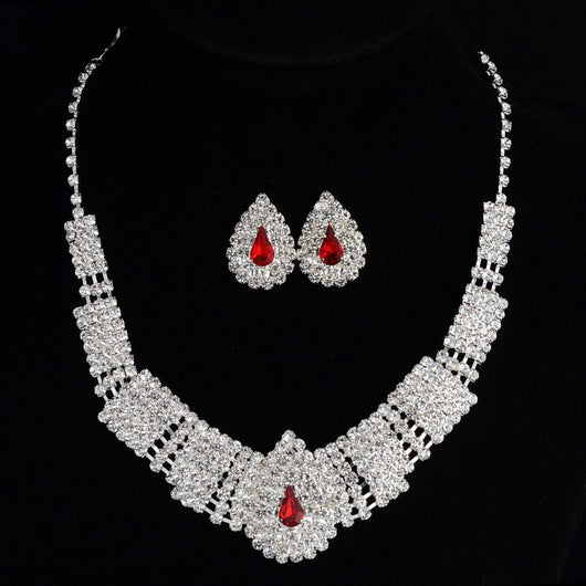 Sparkling bridal necklace and matching teardrop rhinestone earrings set on a black background. - Image 6