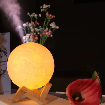 Moon-shaped night light and air humidifier on a wooden stand, emitting mist and a warm glow, with books and flowers. - Image 8