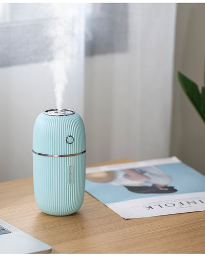 Navy blue portable humidifier with a ribbed texture, silver accents, and a power button on a white background. - Image 2
