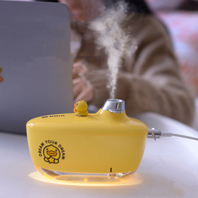 Yellow submarine-shaped portable humidifier with a clear base, a duck figurine, and 'DREAM YOUR DREAM' graphic.