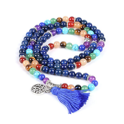Blue mala prayer beads with chakra colored gemstones, a silver Tree of Life charm, and a blue tassel.