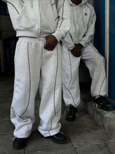 Light gray hooded tracksuit with dark gray contrast stitching, featuring a full-zip hoodie and matching loose sweatpants. - Image 7