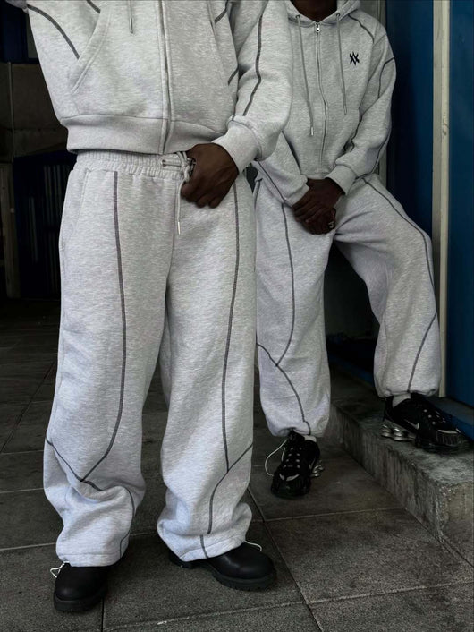 Light gray hooded tracksuit with dark gray contrast stitching, featuring a full-zip hoodie and matching loose sweatpants. - Image 7