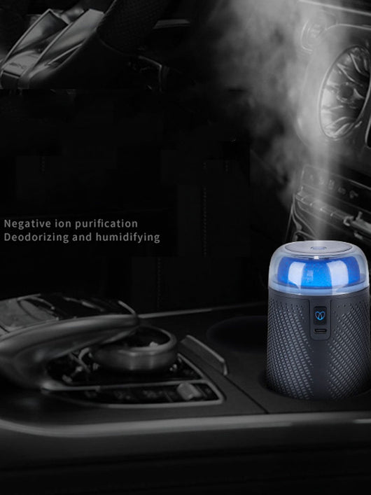 Black car aroma diffuser humidifier with blue light, wireless charging, and automatic spray, shown with six essential oil bottles. - Image 2