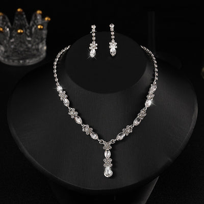 Elegant silver-tone necklace and matching drop earrings set with clear marquise and teardrop stones, displayed on a black bust. - Image 10