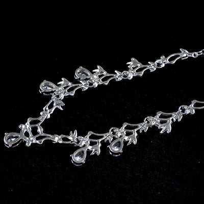 Silver-toned necklace and dangle earrings set with clear teardrop and round cubic zirconia stones in a floral design. - Image 5