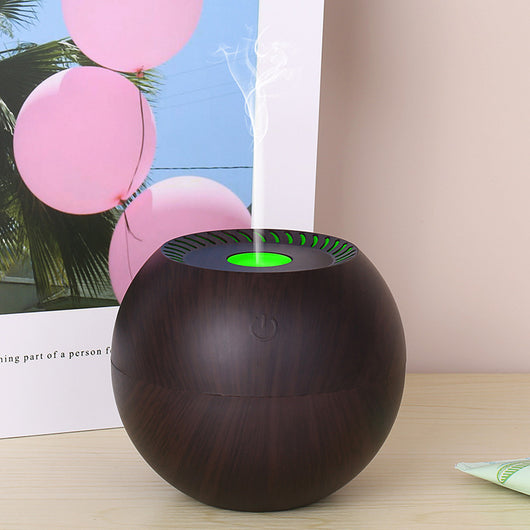 Dark wood grain spherical USB humidifier with a green light and mist emitting from the top, featuring a power button icon. - Image 7