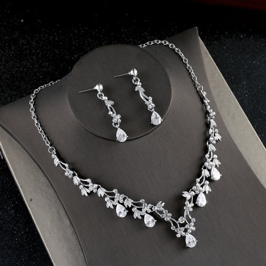 Silver-toned necklace and dangle earrings set with clear teardrop and round cubic zirconia stones in a floral design. - Image 2
