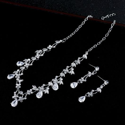 Silver-toned necklace and dangle earrings set with clear teardrop and round cubic zirconia stones in a floral design. - Image 3